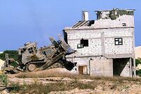 An IDF D9N (2nd generation armor) razing a house during the Second Intifada