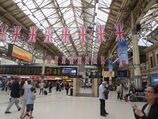 Victoria station concourse. British flags hang from the ceiling.