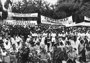 Large crowd, holding banners