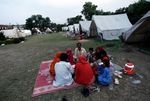 Flood-affected people break their fast on the first day of the Muslim holy fasting month of Ramadan in a camp in Nowshera, Pakistan on Thursday, Aug. 12, 2010. Pakistani flood survivors, already short on food and water, began the fasting month of Ramadan on Thursday, a normally festive, social time marked this year by misery and fears of an uncertain future. (AP Photo/Mohammad Sajjad)